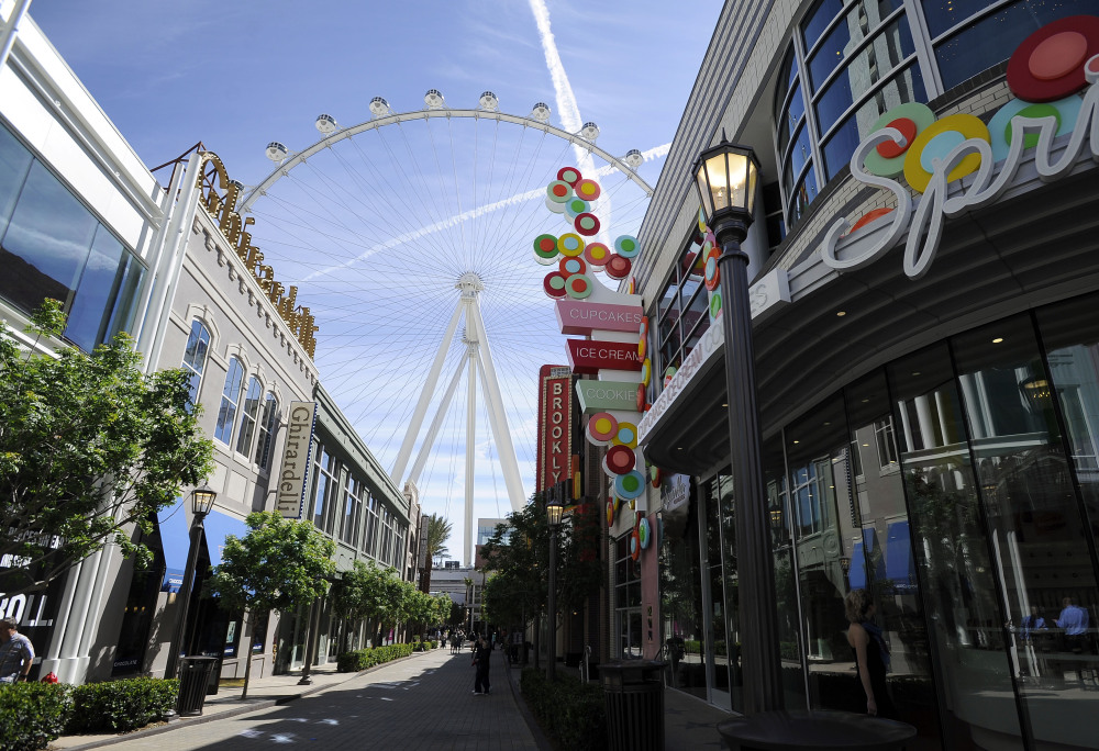 The Las Vegas High Roller towers over the shops at The LINQ. From a distance, the motion of the wheel is nearly imperceptible.