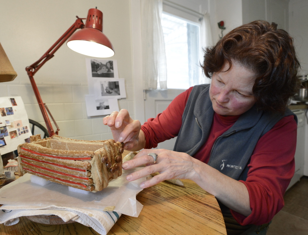 Deborah Klotz of Portland works on her Edible Book Festival entry, centering on Templeton the rat, one of the stars of the children’s book “Charlotte’s Web” by E.B. White. Klotz is shown at work on Wilbur the pig’s trough.