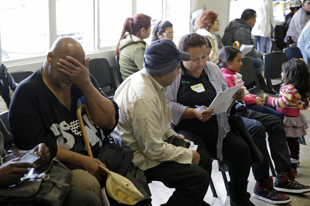Applicants wait to be called during a health care enrollment event at the Bay Area Rescue Mission in Richmond, Calif., on Monday. A few routes remain open for those who missed the health care law’s big enrollment deadline.
