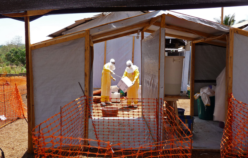 In this photo provided by Doctors without Borders, taken on Friday, March 28, 2014, health care workers from the organisation prepare isolation and treatment areas for their Ebola hemorrhagic fever operations, in Gueckedou, Guinea.