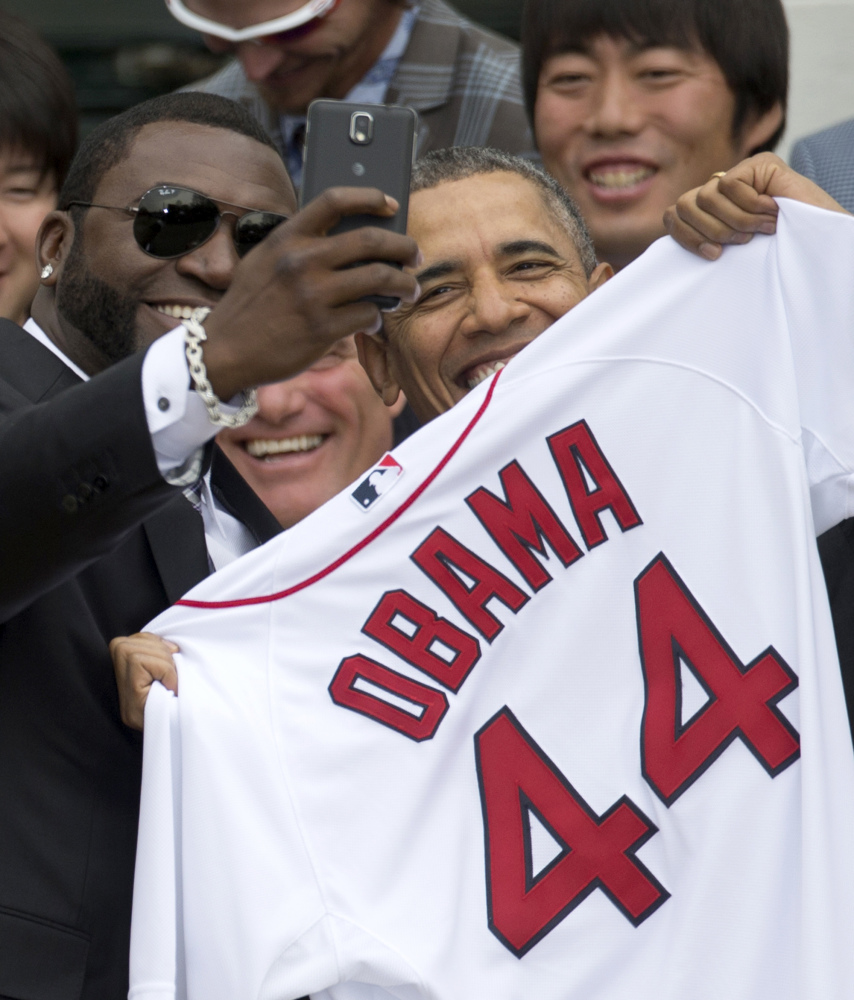President Obama receives a jersey from David Ortiz, left, of the Boston Red Sox in Washington on Tuesday.