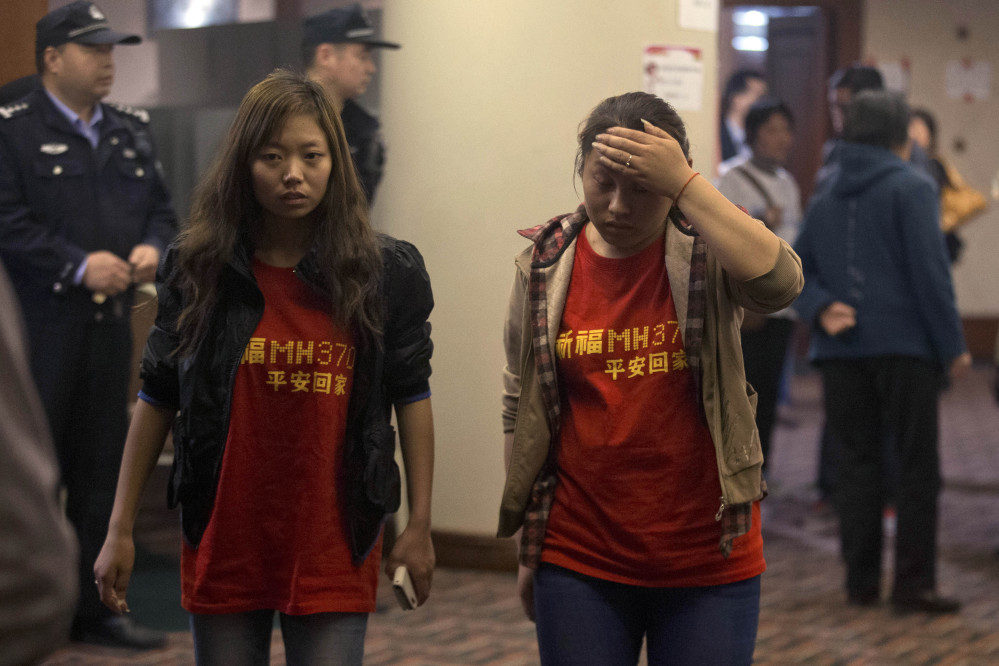 Relatives of the Chinese passengers onboard the Malaysia Airlines flight MH370 wear T-shirts with the words “Pray for MH370, safe return” in Beijing Thursday, April 3, 2014. No trace of the Boeing 777 has been found nearly a month after it vanished in the early hours of March 8 on a flight from Kuala Lumpur to Beijing with 239 people on board.