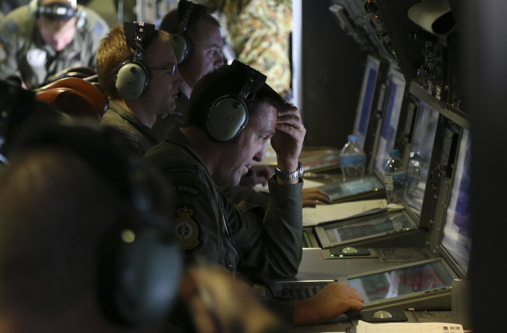 Operators monitor operations aboard a Royal New Zealand Air Force P3 Orion during the search for wreckage and debris of missing Malaysia Airlines Flight MH370 in the southern Indian Ocean, near the coast of Western Australia, on Friday.