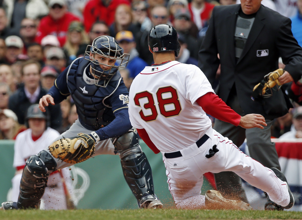 Milwaukee Brewers catcher Jonathan Lucroy prepares to tag out Boston Red Sox’s Grady Sizemore trying to score on a sacrifice fly during the second inning at Fenway Park in Boston on Friday.