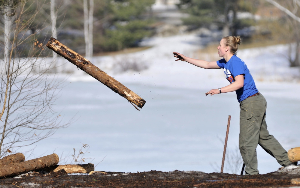 Julia Rogers, a sophomore at Colby College, practices the log toss during on Thursday.