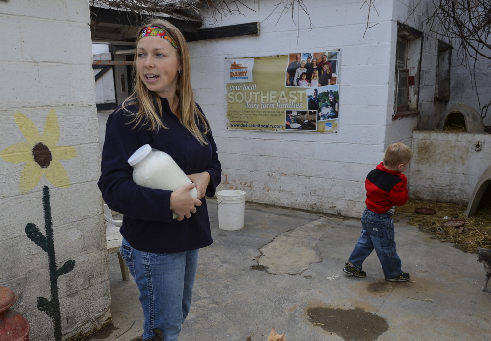 Jen Bernick and her son Solomon, 4, of Winchester pick up a gallon of raw milk at the farm.