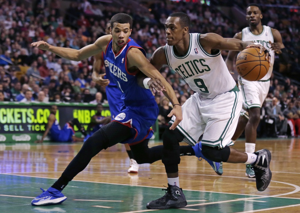 Philadelphia 76ers guard Michael Carter-Williams, left, tries to stop Boston Celtics guard Rajon Rondo on a drive to the basket during the second quarter of Friday’s NBA game in Boston.