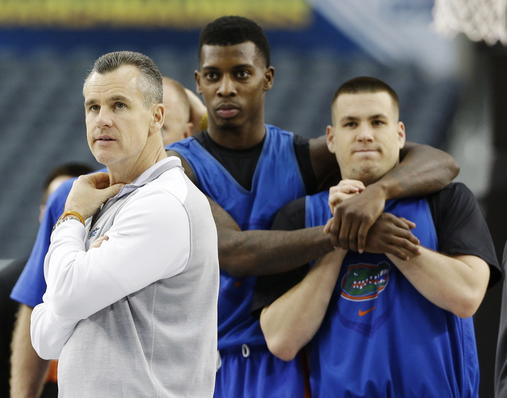 Florida head coach Billy Donovan, from left, forward Chris Walker, and guard Billy Donovan watch a drill during practice for their NCAA Final Four tournament college basketball semifinal game Friday in Dallas.
