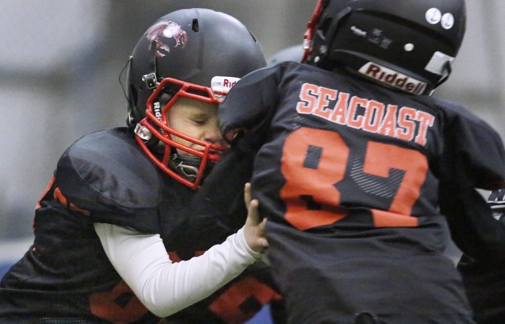 William Hersey, left, hits Ryan Chase as the two take part in a full contact drill during a Seacoast Lobsters practice in February at the York Sports Center. The indoor youth football team based in Eliot quickly attracted third- and fourth-graders and their parents when it formed this winter.
