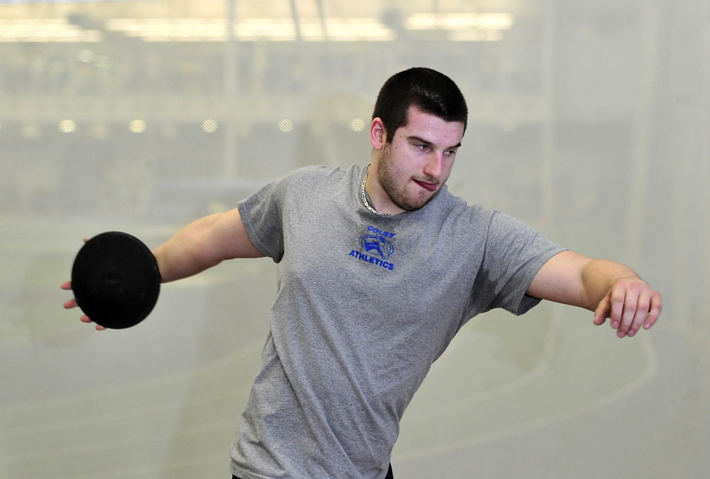 Billy Parker works on his discus-throwing form at Alfond Athletic Center at Colby College last month. Parker, who started playing football as a third-grader in Massachusetts, suffered a concussion during a football practice at Colby last fall and says, “I’m not 100 percent of the way to where I was before the injury.”