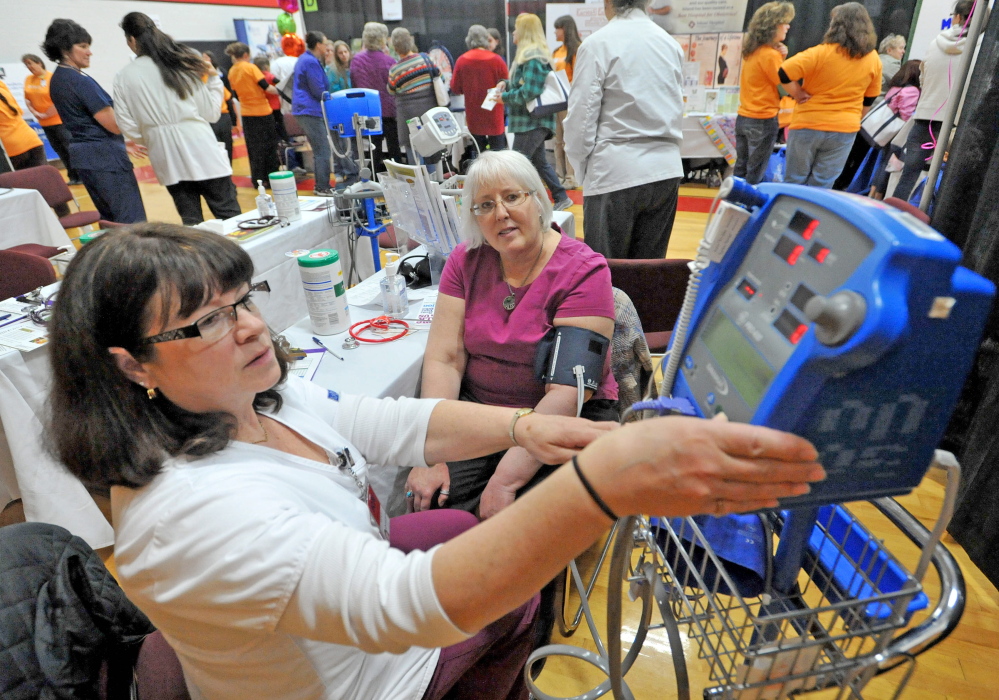Vicki Goodwin, left, a registered nurse at Inland Hospital, checks the blood pressure of Connie Finley on Saturday.