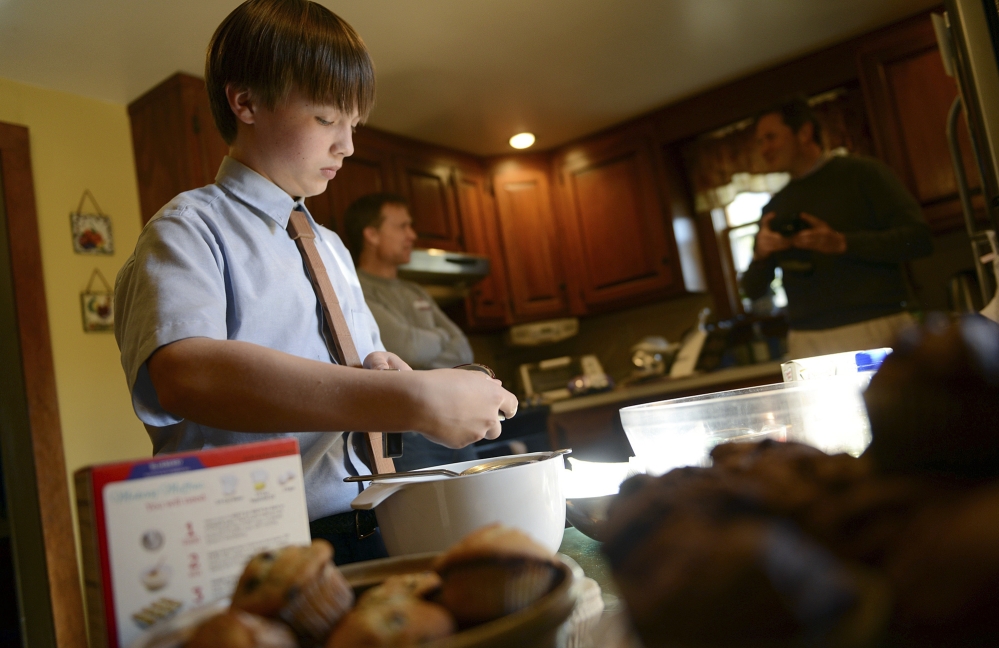David Albright, an eighth-grader at St. Mary’s School, bakes muffins at his home in Milford, Conn. He started making muffins for the homeless when he was 8 years old. He delivered this batch to the Beth El shelter in Milford.