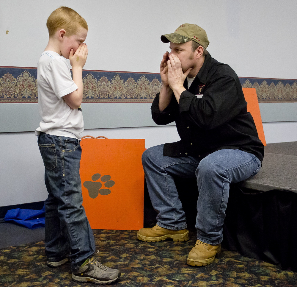 Eight-year-old Owen Heseltine of Chesterville, tutored by Lee Schanz Jr. of the Maine Professional Guides Association last week at the Augusta Civic Center, already is showing signs of being a master moose caller in the making.