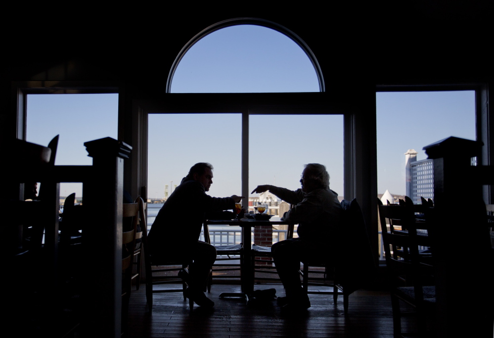 Two patrons enjoy dinner with a view at Joe’s Boathouse in South Portland.