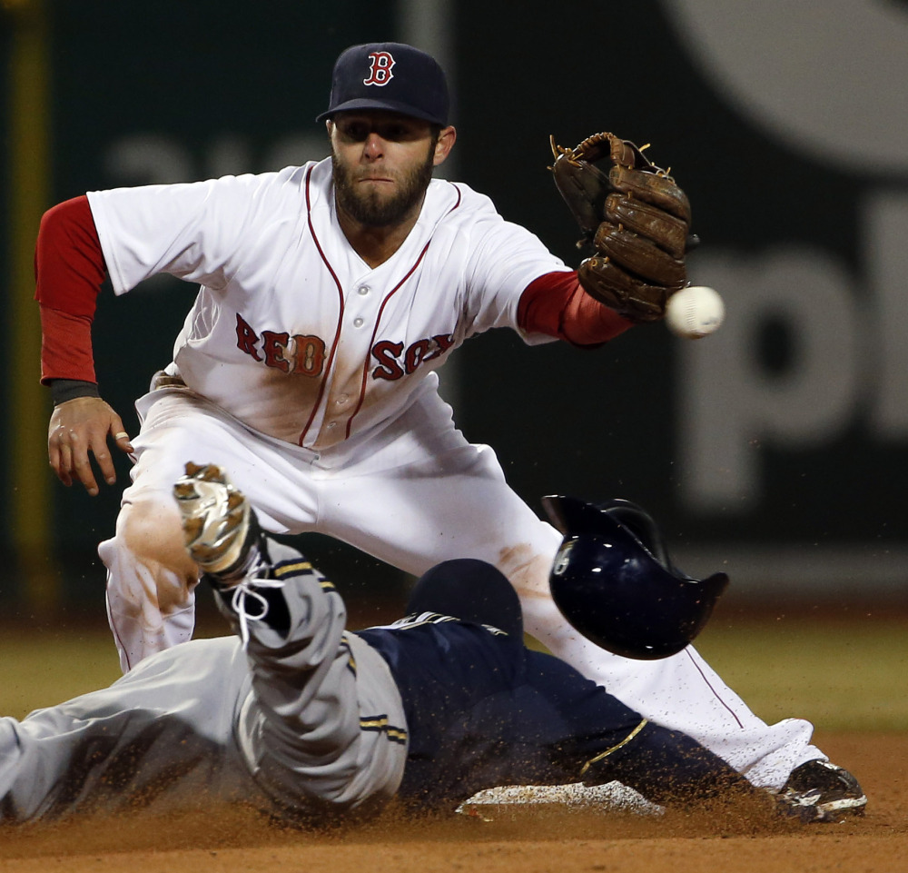 Boston second baseman Dustin Pedroia can’t get to the throw from catcher A.J. Pierzynski as Milwaukee’s Jean Segura steals second base during the eighth inning.