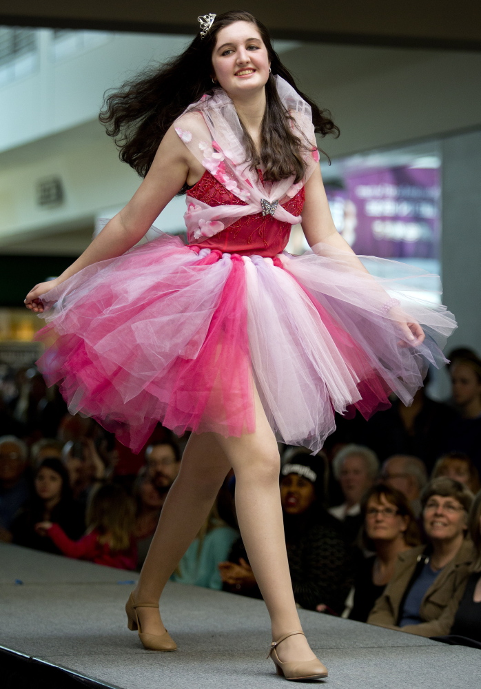 Lauren Tudor, a student at Portland Arts & Technology High School, walks down the runway in the school’s Collection 2014 fashion show at the Maine Mall on Saturday.