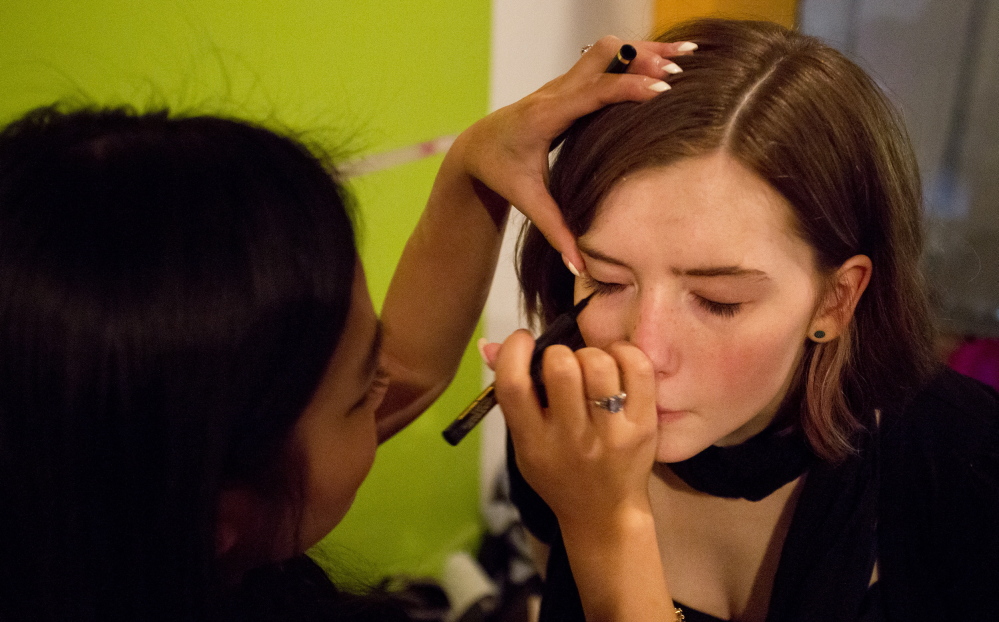 Lillian Gardner, a student/teacher at Portland Arts & Technology High School, carefully applies makeup to Kiera Foley, 16.
