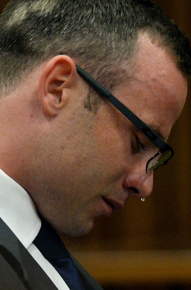 Oscar Pistorius cries in court on March 24 as he listens to evidence being given about his girlfriend’s death.
