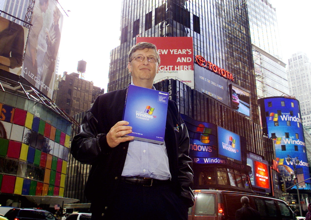 Bill Gates, chairman and chief software architect of Microsoft, holds a copy of Microsoft's Windows XP in New York's Times Square in 2001.