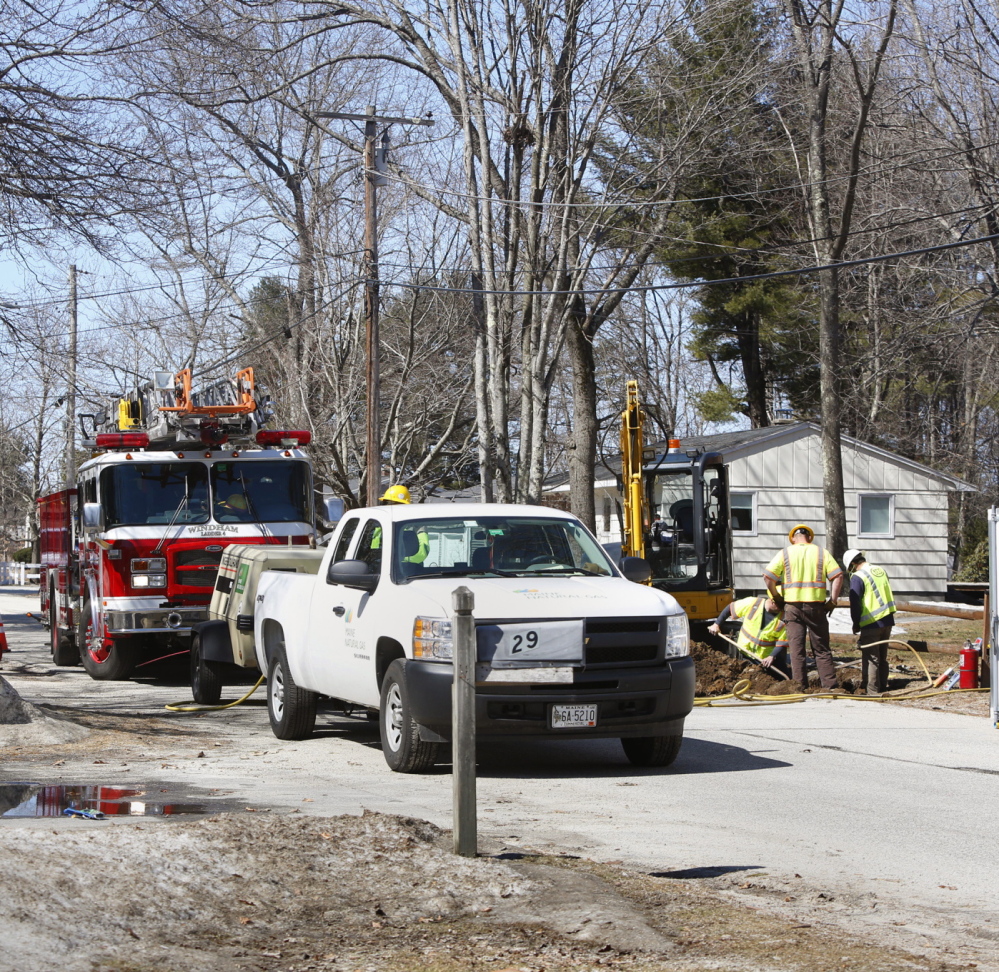 Workers replace a valve on a gas line after a leak on Abby Road in North Windham on Sunday. Four residences were evacuated Sunday morning.