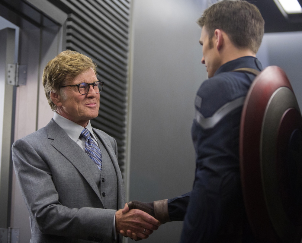 Chris Evans, right, and Robert Redford in a scene from “Captain America: The Winter Soldier.” The film debuted in the U.S. with a take of $96.2 million.