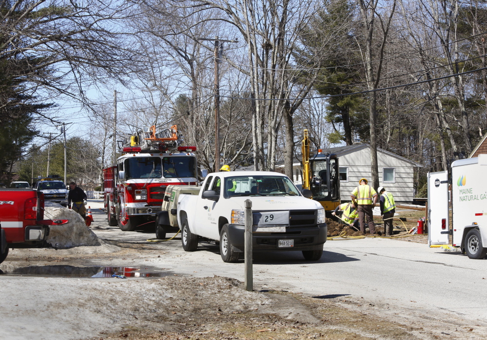 Workers replace a valve on a gas line after a gas leak on Abby Road in North Windham on Sunday. Four homes were evacuated Sunday morning.