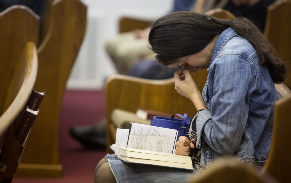 Kathy Abad, a military wife, prays for the victims and families affected by the Fort Hood shooting during a service Sunday at the Tabernacle Baptist Church in Killeen, Texas.