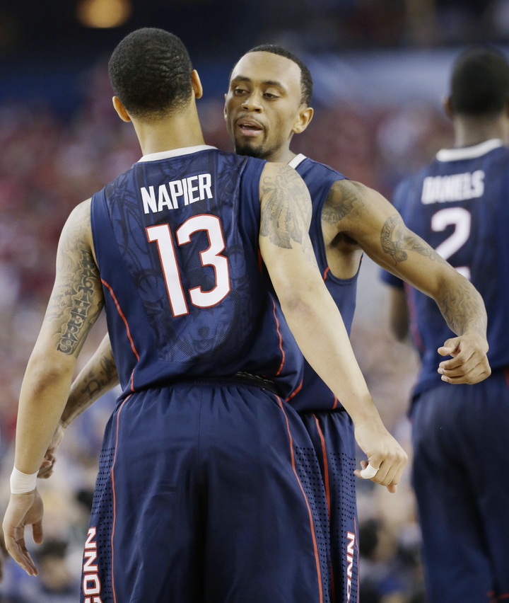 Connecticut guard Shabazz Napier (13) and guard Ryan Boatright celebrate during the second half of the NCAA Final Four Saturday in Arlington, Texas.