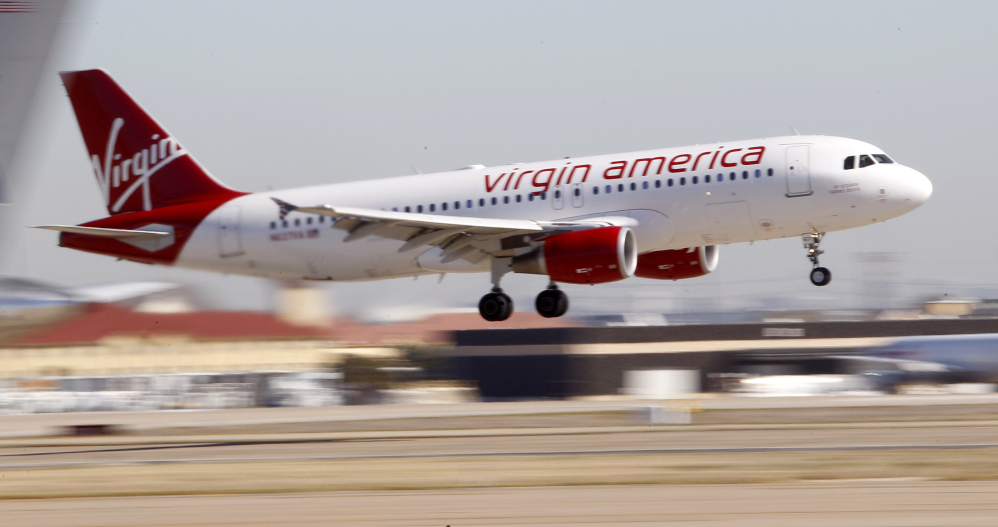In this Dec. 1, 2010 file photo, Virgin America’s inaugural flight between Los Angeles an Dallas Fort Worth International Airport comes in for a landing in Grapevine, Texas. Virgin America topped the latest ratings of airlines.
