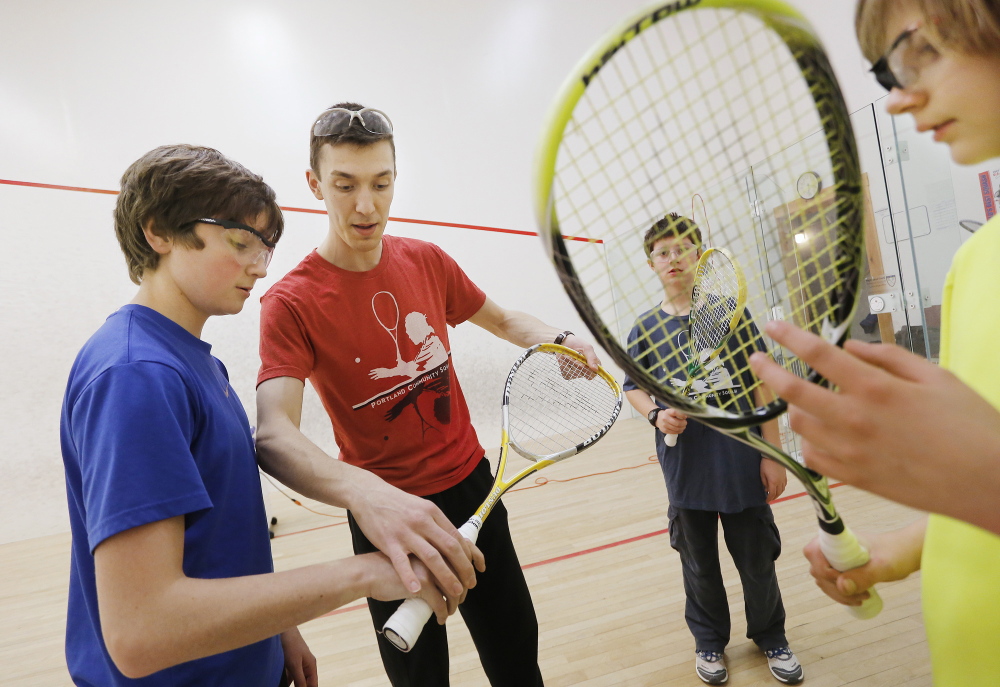 Barrett Takesian trains middle school students during a squash practice at the Portland YMCA.