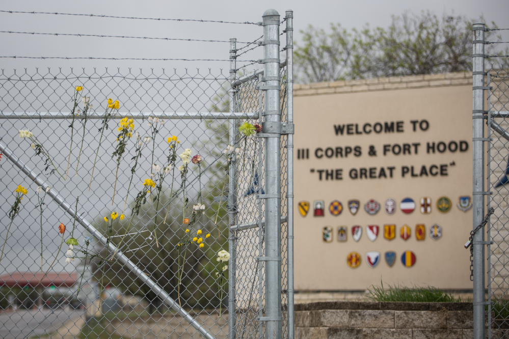 Flowers adorn a fence outside of Fort Hood’s east gate on Sunday in Killeen, Texas, in honor of those killed and wounded in the Fort Hood shooting on April 2.