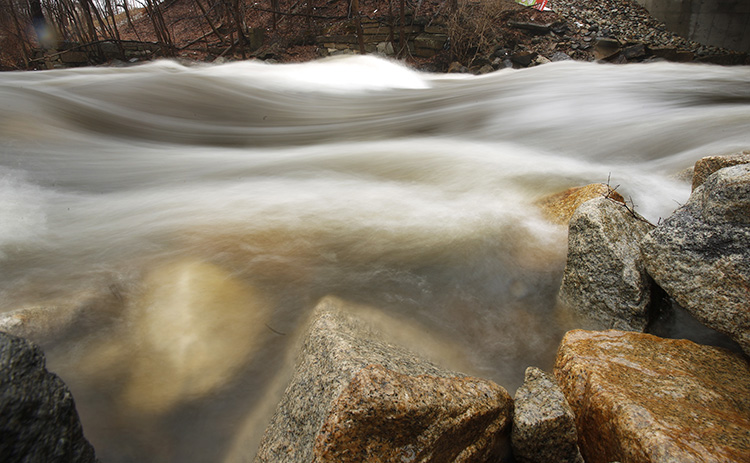 Water rushes over rocks in the Mousam River in Kennebunk on Tuesday. The National Weather Service has issued a flood watch because heavy rains overnight are causing rivers to swell.
