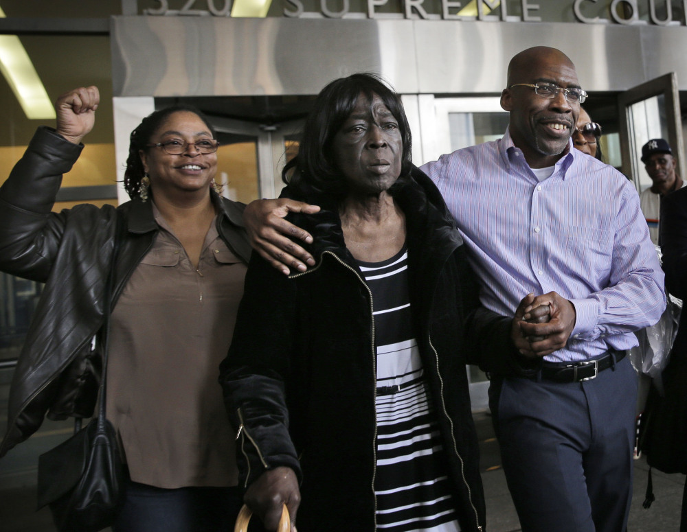 Jonathan Fleming exits the courthouse with his mother, Patricia Fleming, second from right, in New York on Tuesday after he spent nearly 25 years in prison.