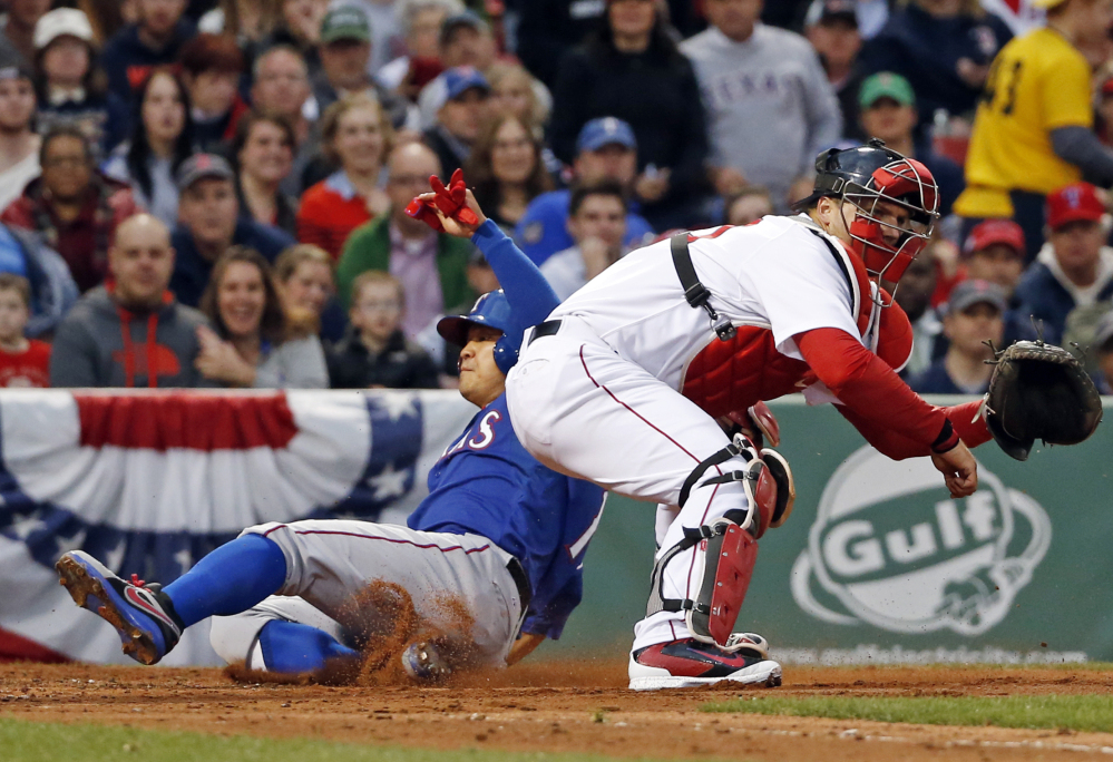 Texas Rangers’ Shin-Soo Choo scores on a double by Prince Fielder as Boston Red Sox catcher A.J. Pierzynski waits for the ball in the third inning of a baseball game at Fenway Park in Boston, Tuesday, April 8, 2014.