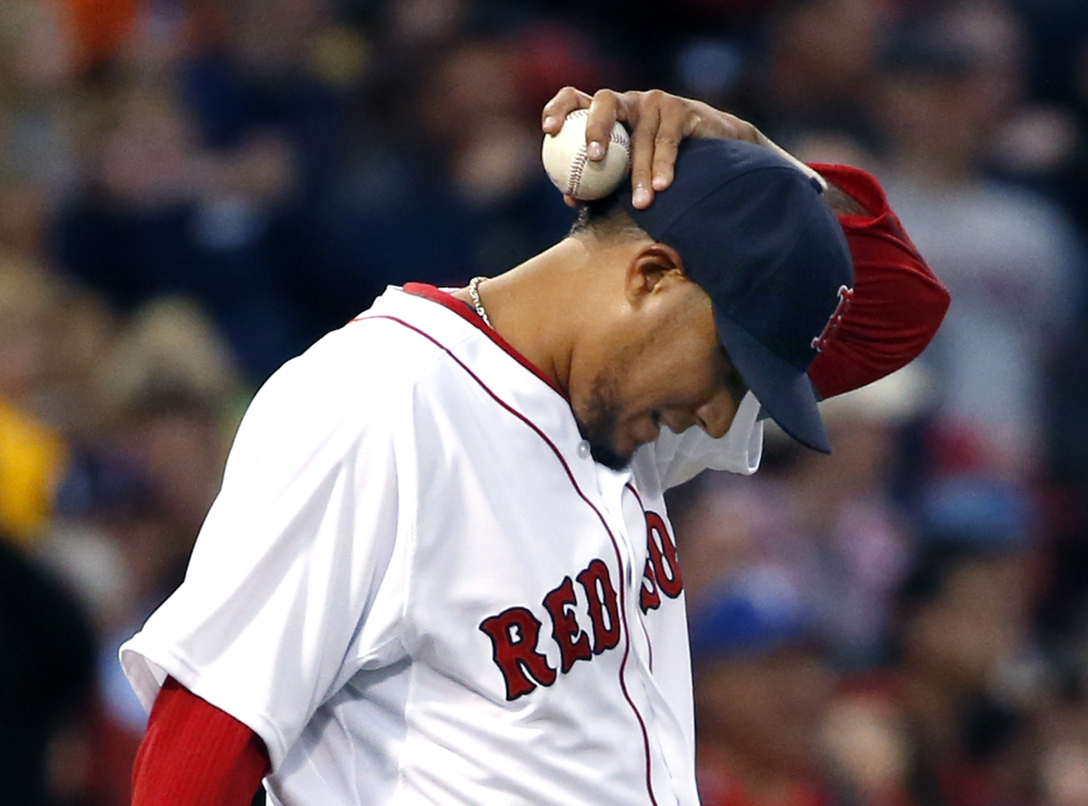 Boston Red Sox starting pitcher Felix Doubront reacts on the mound after giving up runs to the Texas Rangers in the third inning of a baseball game at Fenway Park in Boston, Tuesday, April 8, 2014.