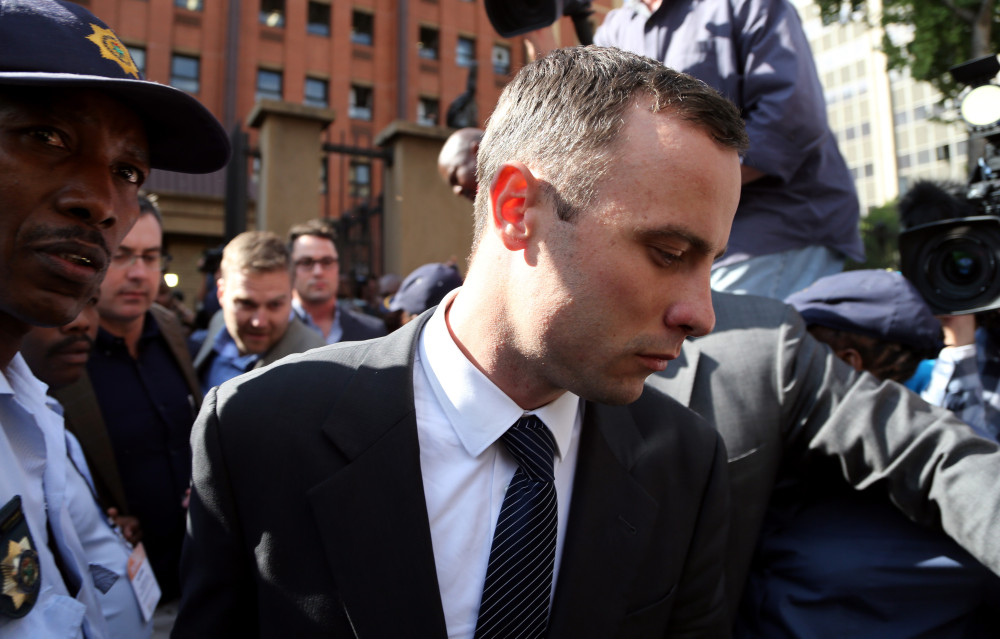 Oscar Pistorius leaves the high court in Pretoria, South Africa, on Tuesday. The Olympian is charged with premeditated murder in Reeva Steenkamp’s death and faces a life sentence with a minimum of 25 years before parole if convicted on that charge.