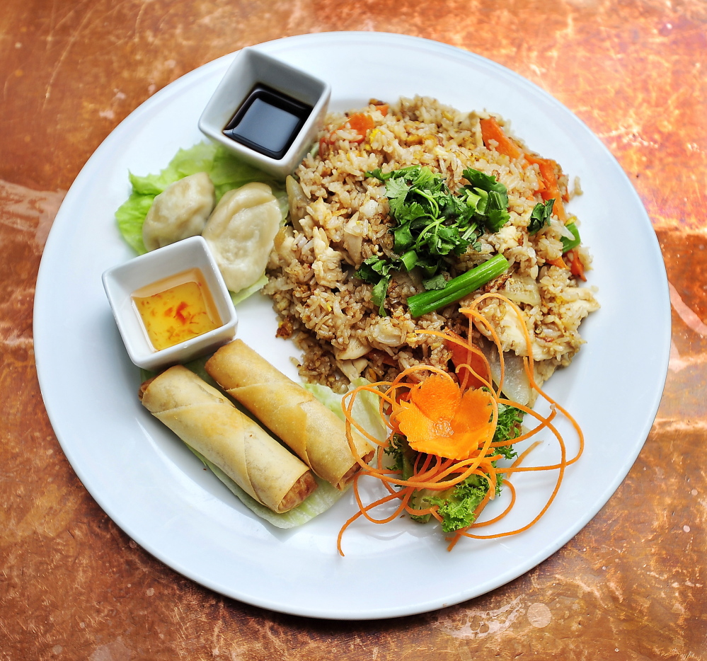 The Thai fried rice lunch special at Chaba Thai Cuisine, with chicken, egg, carrot, onion and scallion, with sides of dumplings and vegetable egg rolls.