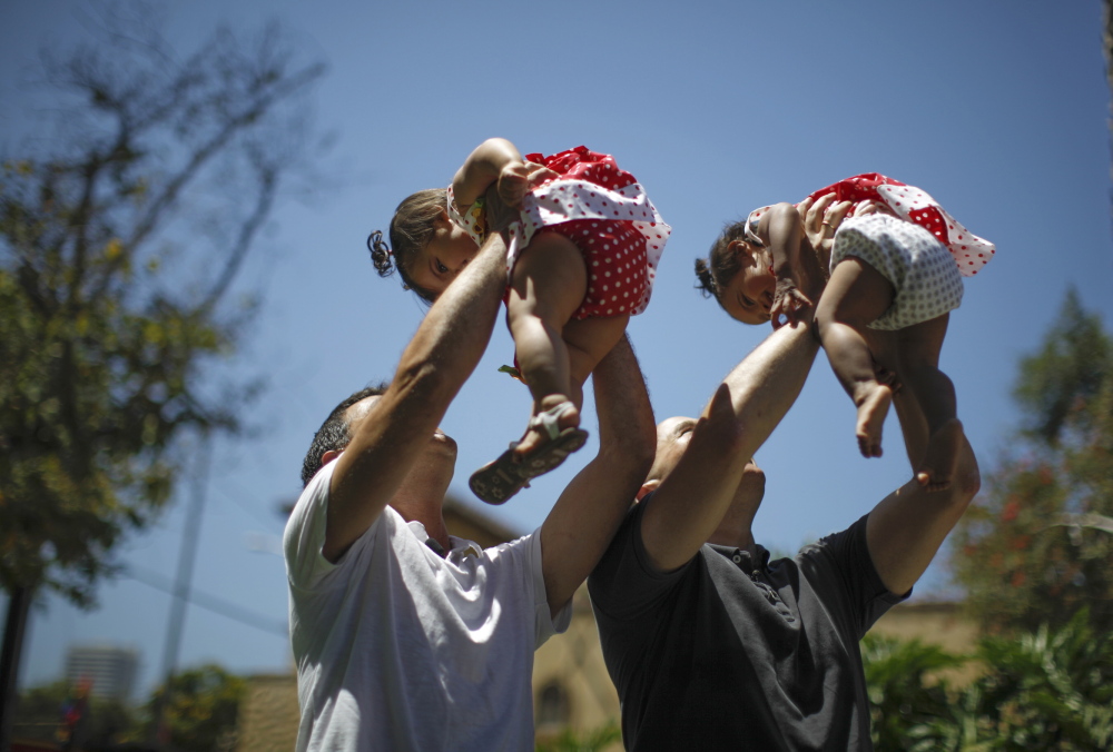 Jason Howe, 48, and Adrian Perez, left, 48, who were married in California, hold their 1-year-old twin daughters at a playground last year as legal momentum was building across the country in favor of same-sex marriage. An appeals court in Denver will hear a case Thursday that could have a major impact on whether that momentum can continue.