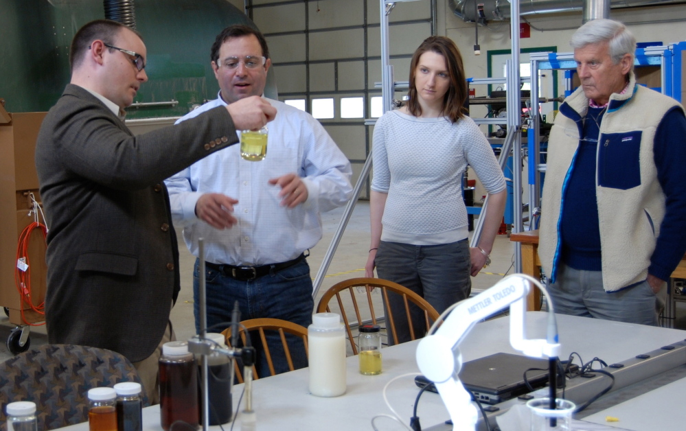 Scott Eaton, left, CTO for SeaChange Group, talks with Joe Migliaccio and Jessica Watson of the Maine Technology Institute and Sam Bishop, interim CEO of SeaChange, at the company’s lab in Bucksport.