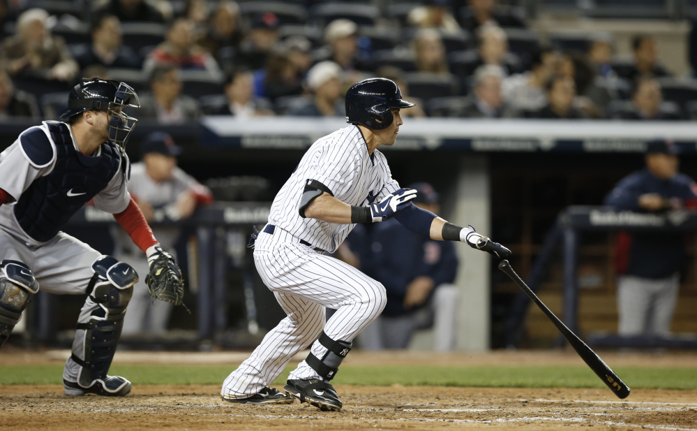 New York Yankees’ Jacoby Ellsbury, right, hits a fifth-inning RBI-double in Thursday’s game against the Boston Red Sox at Yankee Stadium in New York.