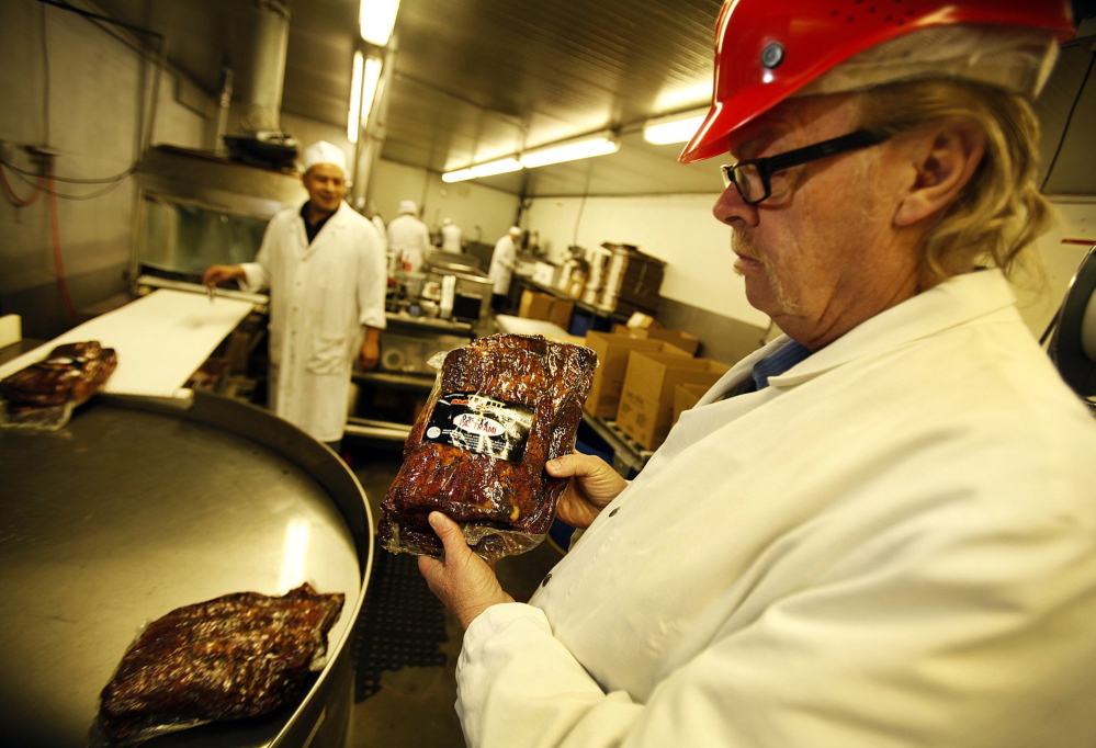 Jerry Haines, right, general manager at R.C. Provisions in Burbank, Calif., holds packaged pastrami ready for shipping. Beef prices are at record highs because of thinning cattle herds decimated by drought. The nearly 50-year-old company’s soaring cost of raw materials has driven their profit margins to near zero.