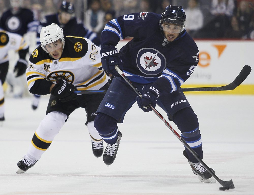 Boston Bruins’ Brad Marchand chases down Winnipeg Jets’ Evander Kane during the second period of Thursday’s NHL game in Winnipeg, Manitoba.