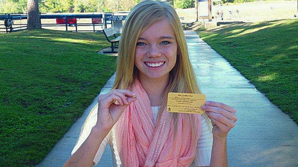 This photo provided by Crater of Diamonds State Park shows Tana Clymer, 14, of Oklahoma City, with a 3.85-carat canary diamond she discovered Oct. 19, 2013. The park is the only diamond-producing site in the United States that is open to the public.