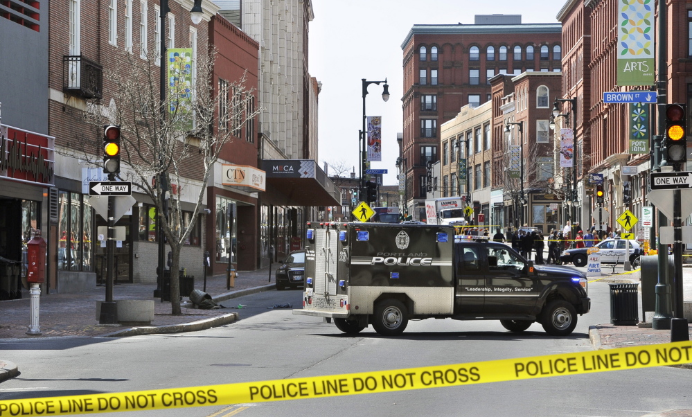 Congress Street in Portland is blocked as police bomb squad members dispose of a device used in a robbery Friday morning at the CVS drugstore at 510 Congress St.
