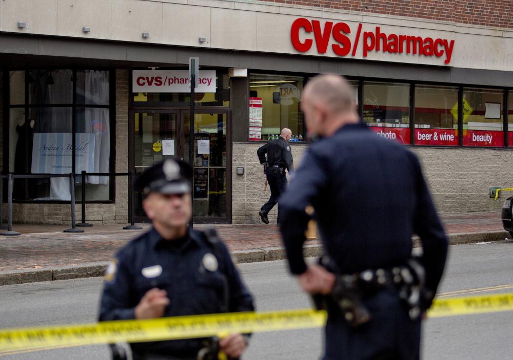 Portland police investigate the robbery of the CVS store at 510 Congress St. Friday.
