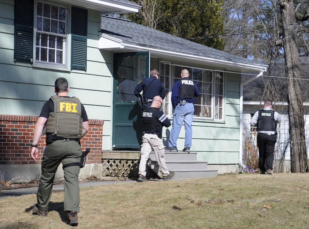 Police search the Augusta residence on Thursday where Gretchen Patrick, 51, was summoned on a charge of sex trafficking. Police allege that Patrick operated Sarah’s Place from a mobile home on Route 126 in Litchfield.