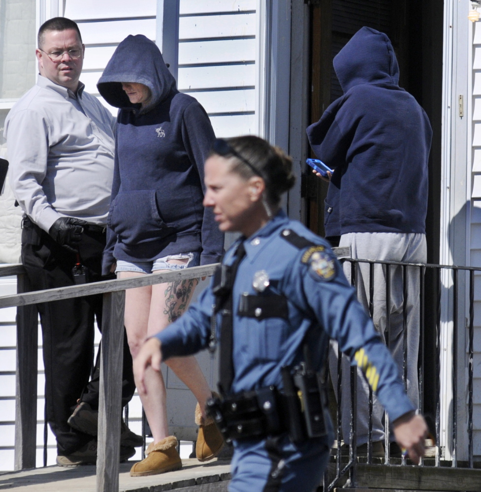 Maine State Police troopers speak with women at the Sidney residence of Frederick Horne Sr. on Thursday following a raid by several law enforcement agencies. Horne and his son, Frederick Horne Jr., were summoned on a charge of sex trafficking.