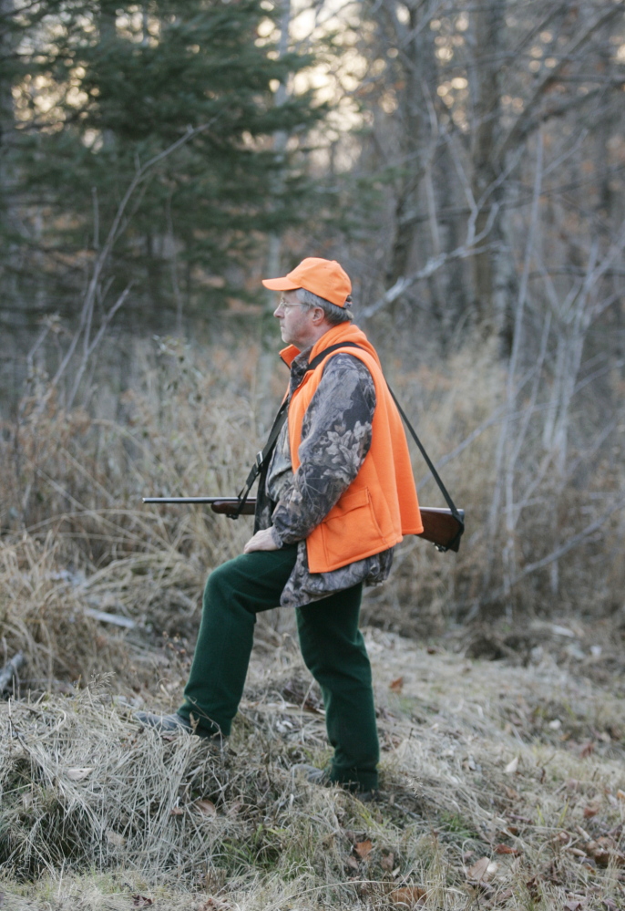 David Lowell scans the woods for deer on the tote road into Moose-Valley-Camp in western Maine. Hunters are seeing fewer deer in northern and western Maine, despite programs to cull predators and to plant food for deer.