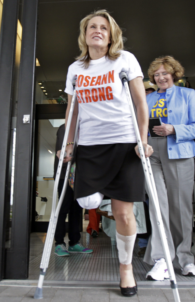 Boston Marathon bombing survivor Roseann Sdoia leaves Spaulding Rehabilitation Hospital in Boston a month after being injured at the finish line on April 15, 2013. She continues to live and work in Boston.