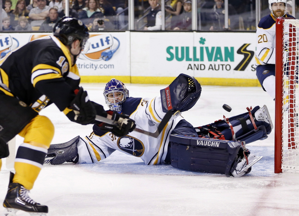 Reilly Smith of the Bruins shoots wide of Sabres' goalie Matt Hackett in the second period Saturday at TD Garden in Boston.